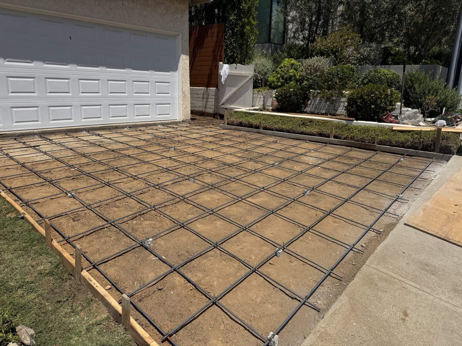 Steel grid set on the prepared driveway base before the concrete pour in Culver City